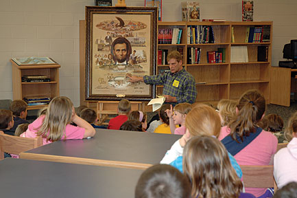Artist Thomas Kennedy speaks to students at Luce Elementary School in Spencer County on Tuesday. Kennedy spent two years working on the painting as a tribute for the Abraham Lincoln Bicentennial Celebration.